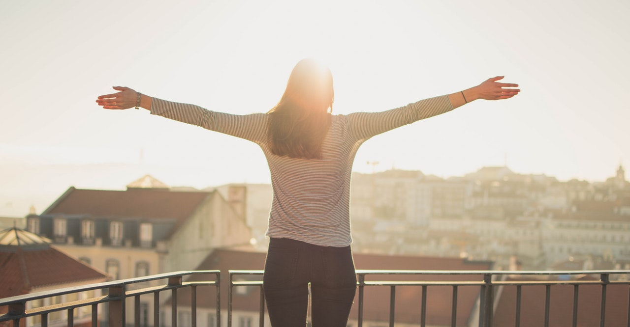 a woman facing the sun outdoor