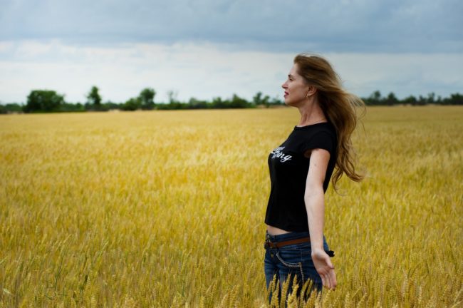 a happy woman in a field